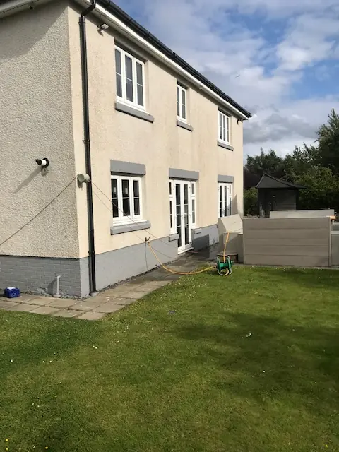 Clean cream render on a two-storey home after soft washing